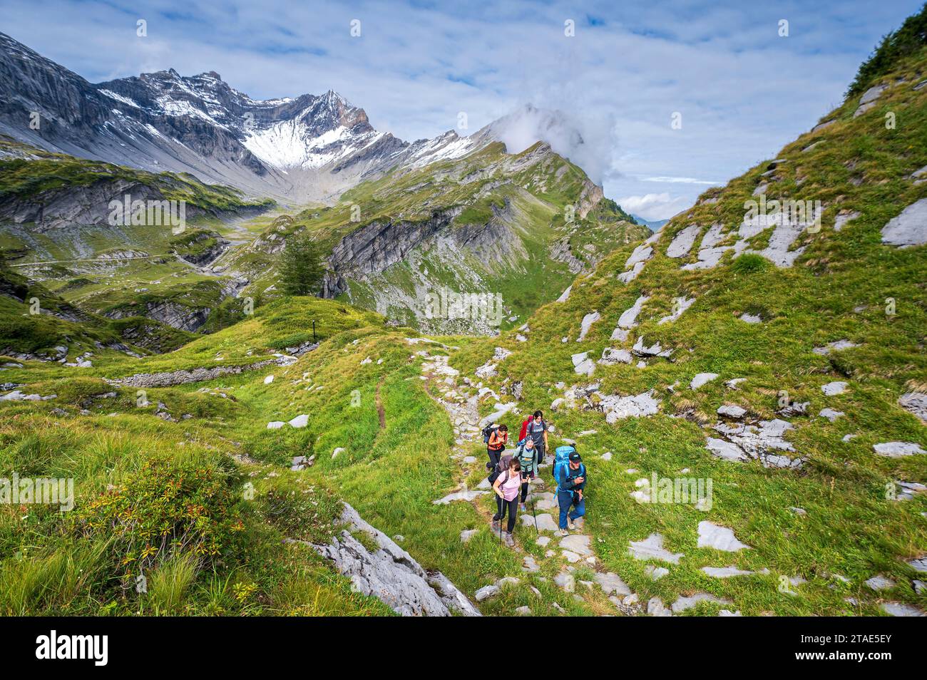 Switzerland, Valais, Champéry, Tour des Dents Blanches, hikers walking towards the Cabane de Susanfe (2101m), in the background you can see the Dent de Barme (2759m) and the Dent de Bonavo (2503m) Stock Photo