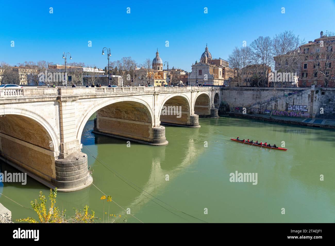 bridge over the river tiber between the two banks of the italian city ...
