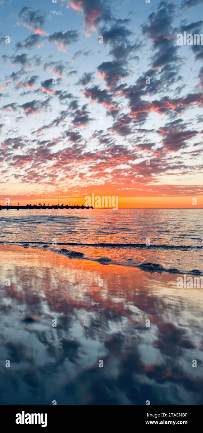 Clear blue sky with white fluffy clouds displayed in the reflection of ...