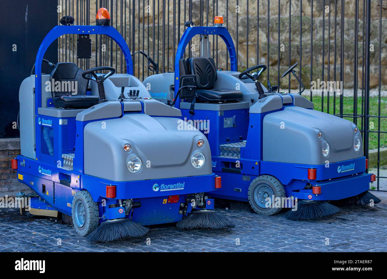 two blue urban hygiene vehicles for cleaning the public road stopped without a driver, Rome, Italy.11-11-2023 Stock Photo