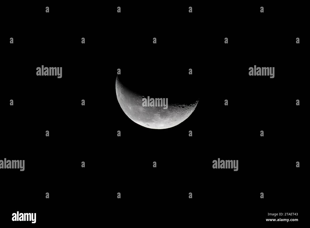 Full moon twilight with craters on the surface and dark sky, close up