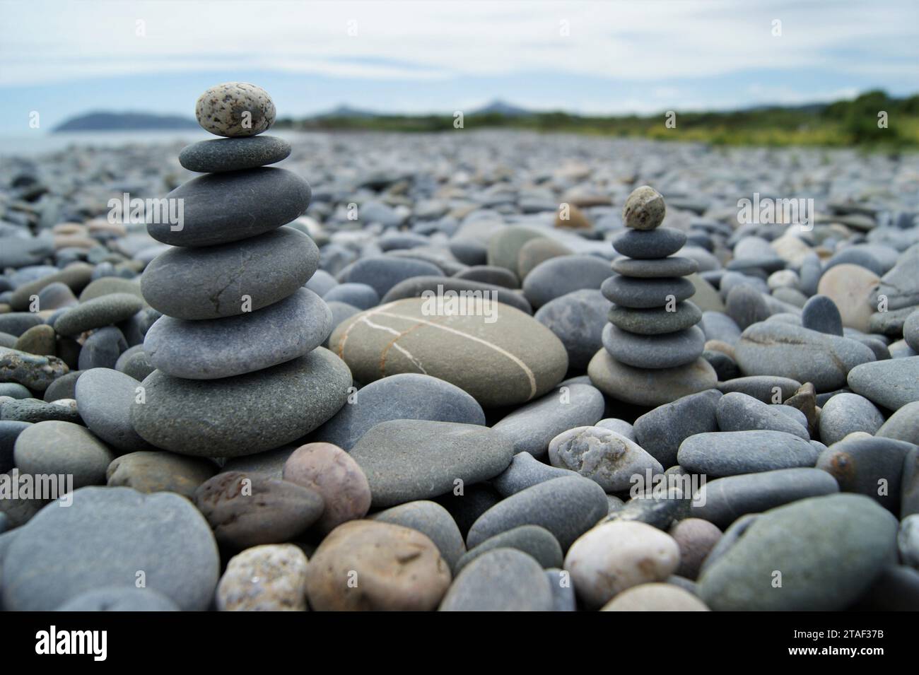 Towers made of pebbles. Two Zen towers on a stony beach. Stock Photo