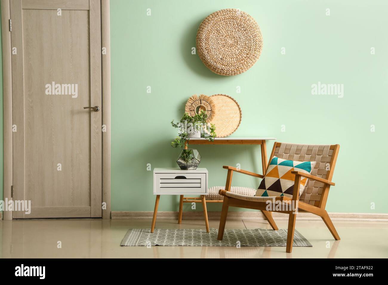 Interior of living room with wooden armchair and tables Stock Photo - Alamy