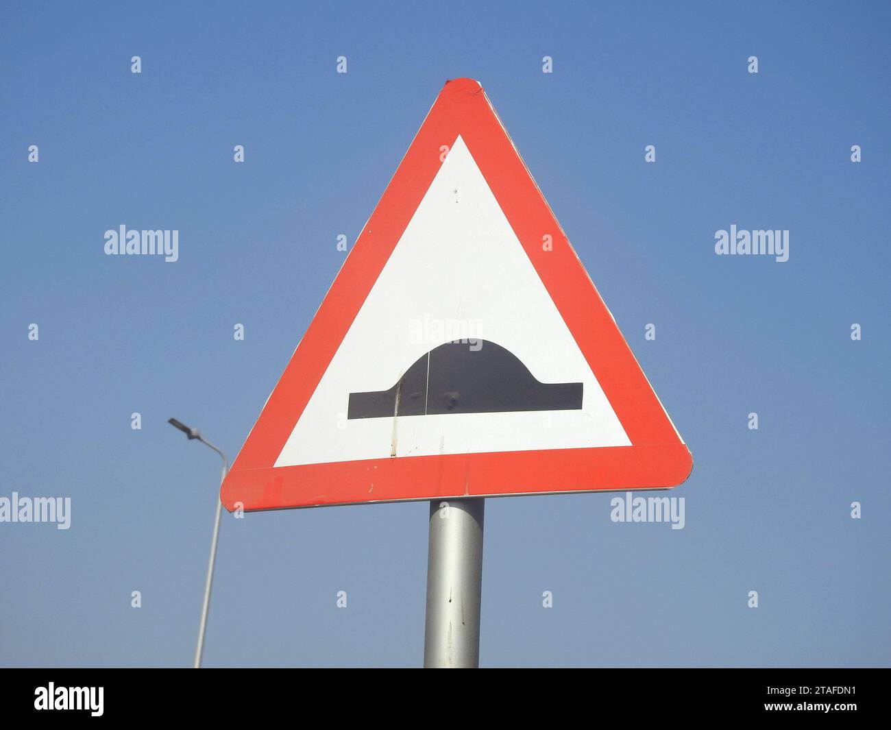 A signboard for Speed bumps ahead, to warn the drivers to be careful and slow down, traffic thresholds, breakers or sleeping policemen, a class of tra Stock Photo