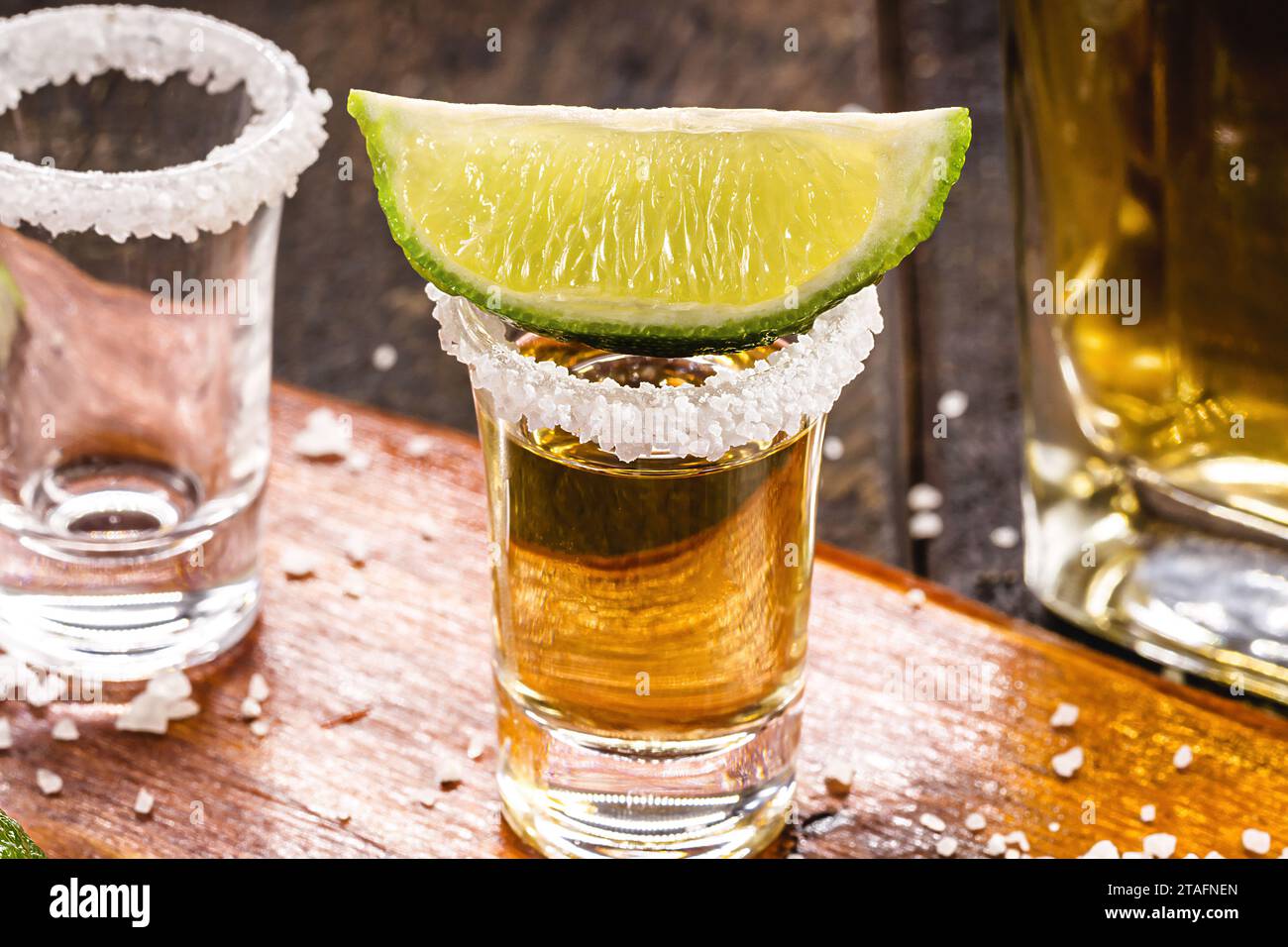 glass of tequila with ingredients around, mexican drink preparation Stock Photo Alamy