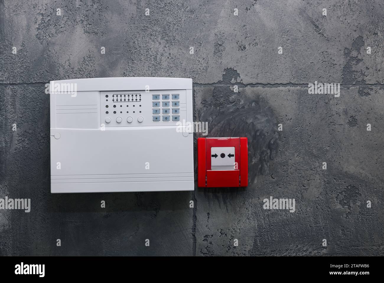 Fire alarm push button and house security system control panel on grey ...