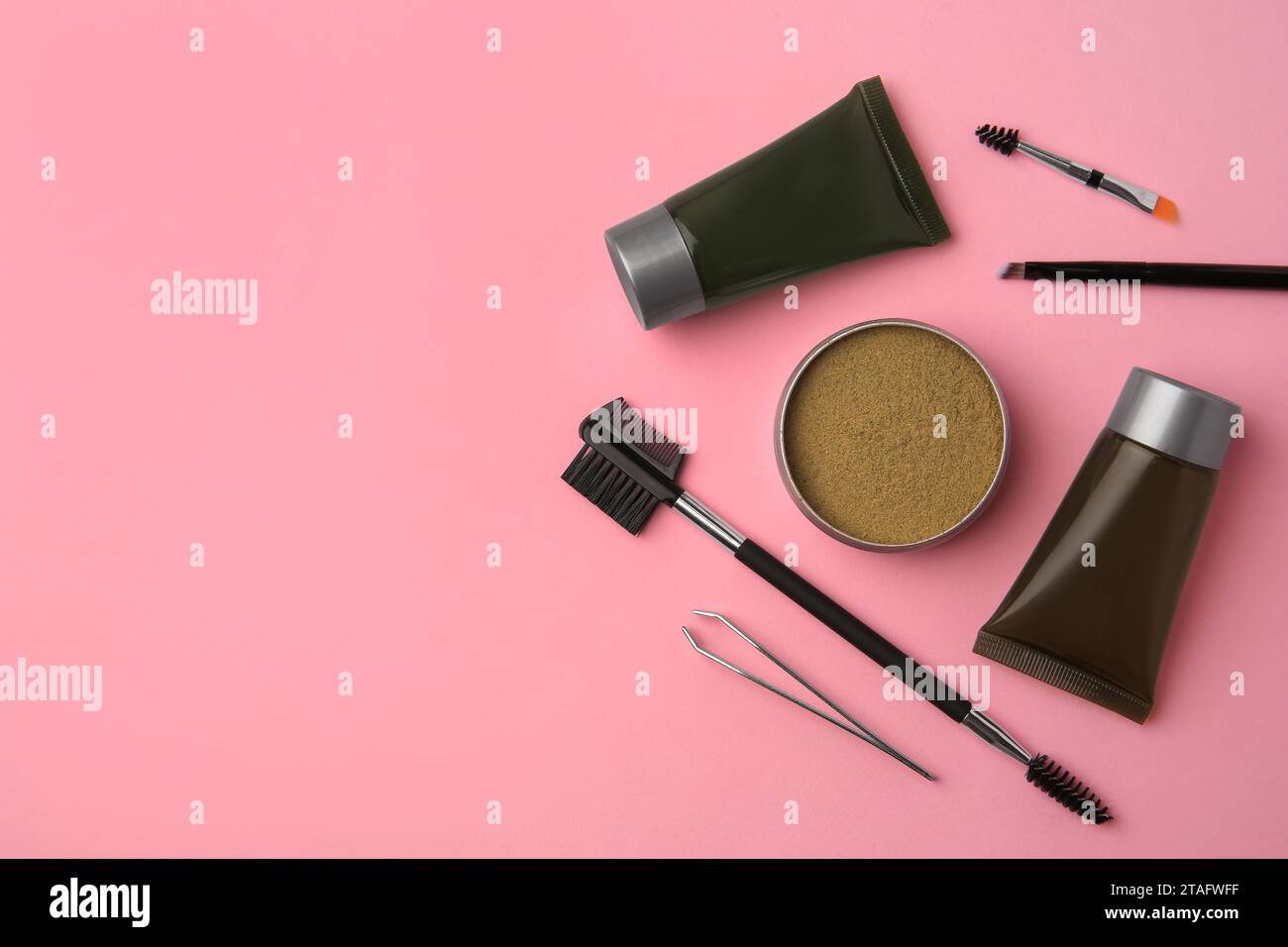 Flat lay composition with eyebrow henna and tools on pink background. Space for text Stock Photo