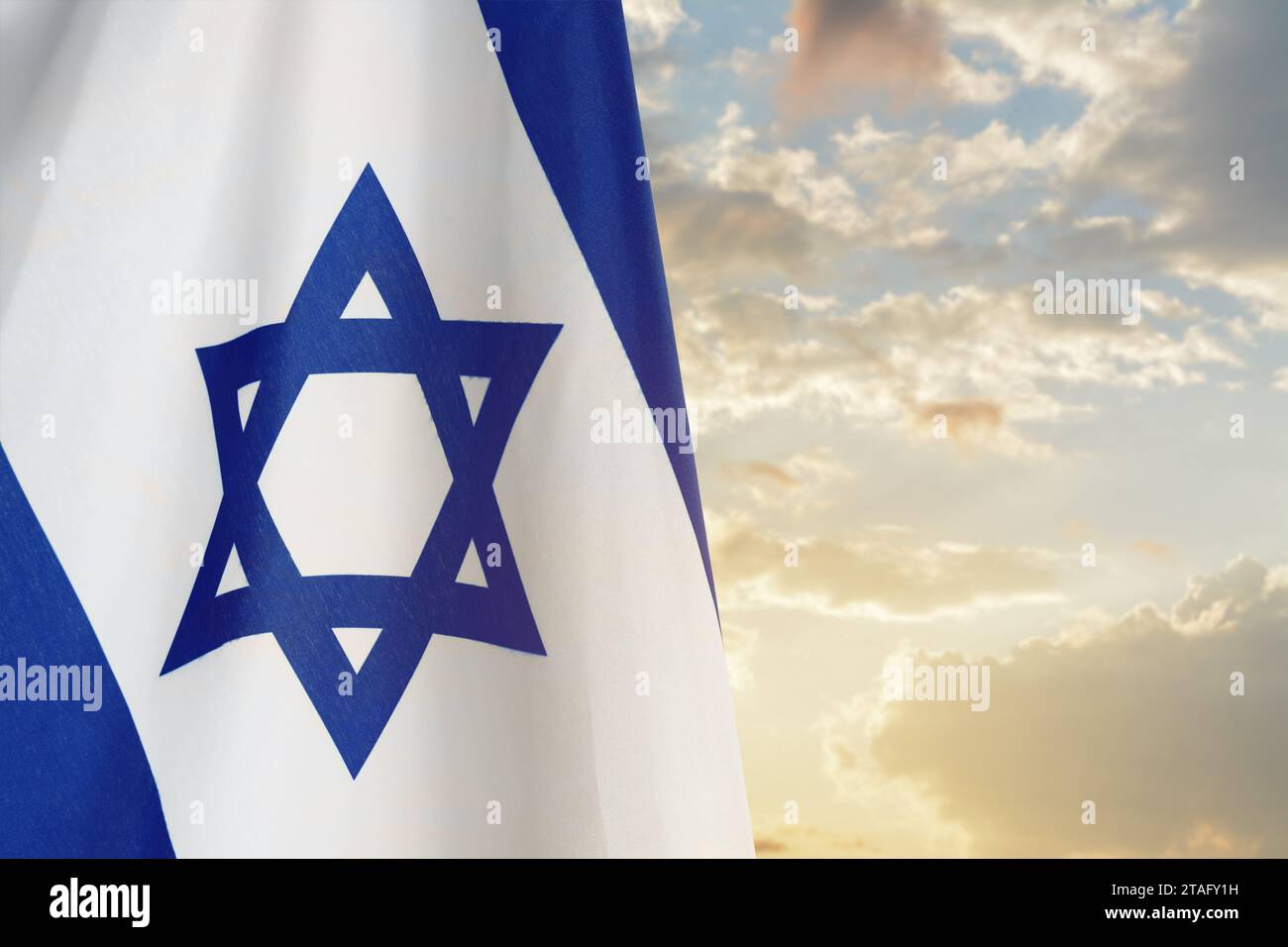 National flag of Israel against blue sky with clouds Stock Photo - Alamy