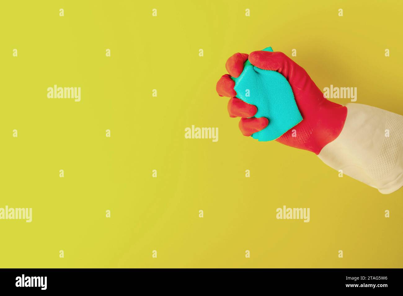 Hand in a rubber glove holds a sponge for washing dishes Stock Photo ...