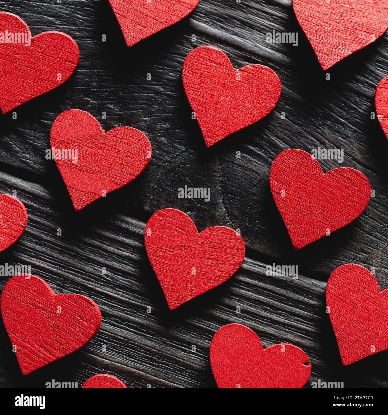 Red wooden hearts on black wooden background Stock Photo - Alamy