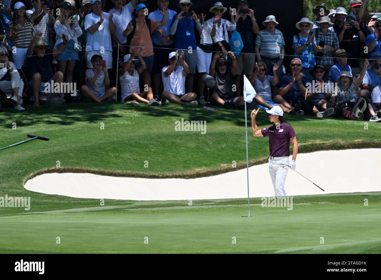 1st December 2023; The Australian Golf Club and The Lakes Golf Club, Sydney, New South Wales, Australia; ISPS HANDA Australian Open Round 2; Min Woo Lee  of Australia chips into the hole from the bunker on the 4th hole and acknowledges the crowd Stock Photo