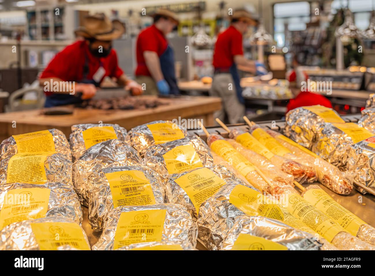 Ready-made BBQ items await while employees chop brisket and prepare sandwiches at Buc-ees mega travel center along I-95 in Daytona Beach, Florida. Stock Photo