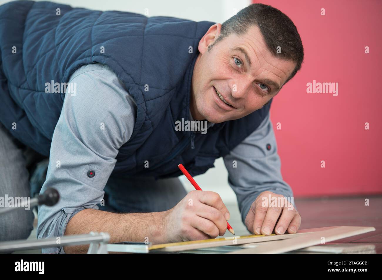 carpenter marking straight line on plywood sheet Stock Photo Alamy