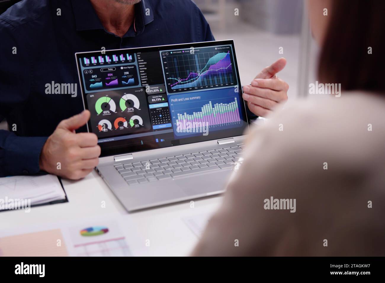Businesspeople and Financial Analysts Analyzing Data on Laptop Stock Photo