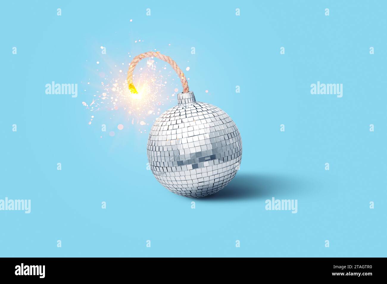Disco mirror ball bomb with wick and sparks on blue background, creative idea. New Year and Christmas. Explosive music, concept Stock Photo