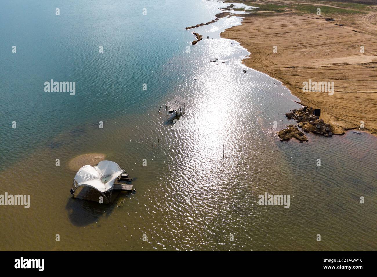 Rising water level on a lake with a flooded shore, aerial view Stock Photo