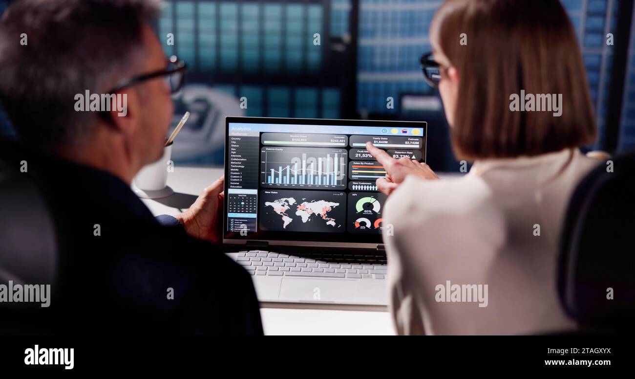 Analyzing KPIs and Report with Laptop's Graphs on Dashboard Stock Photo