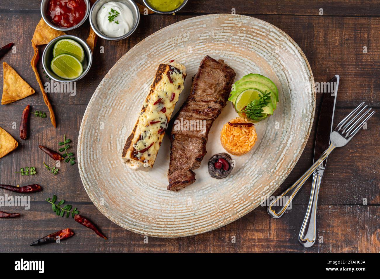 Mexican food carne a la tampiquena with sauces on wooden table Stock Photo