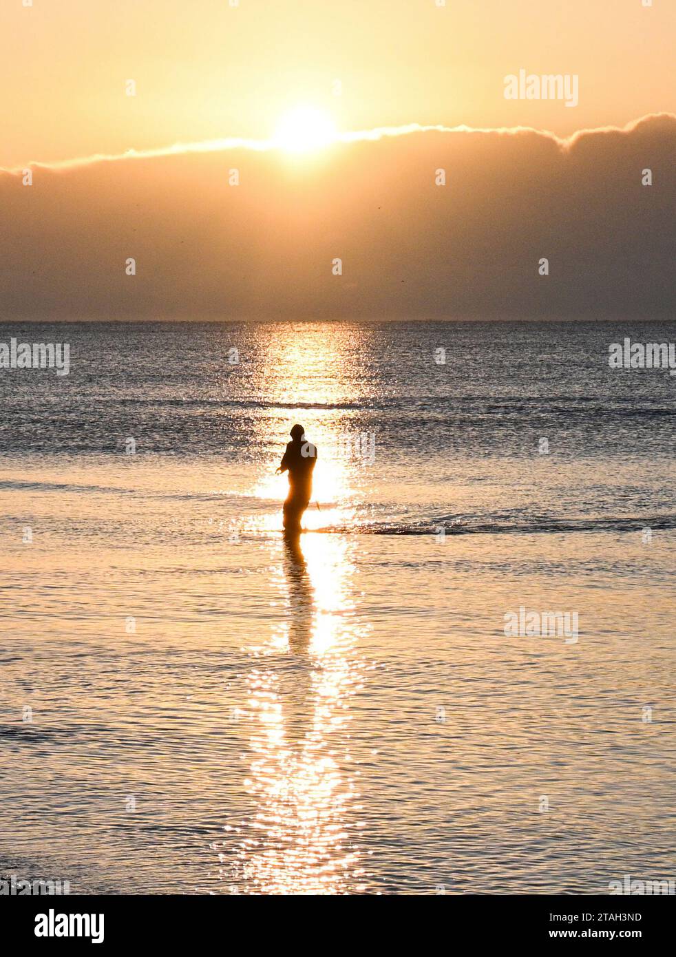Brighton UK 1st December 2023 - A sea swimmer braves the freezing conditions in Brighton at sunrise this morning after the coldest night of the season so far throughout Britain : Credit Simon Dack / Alamy Live News Stock Photo
