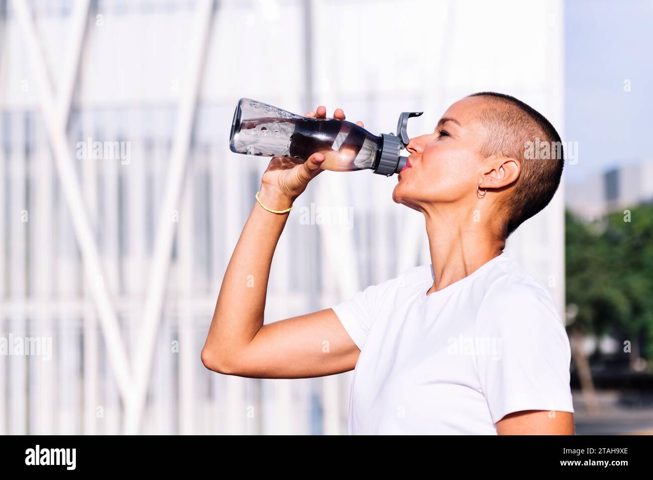 happy young woman drinking water during training Stock Photo