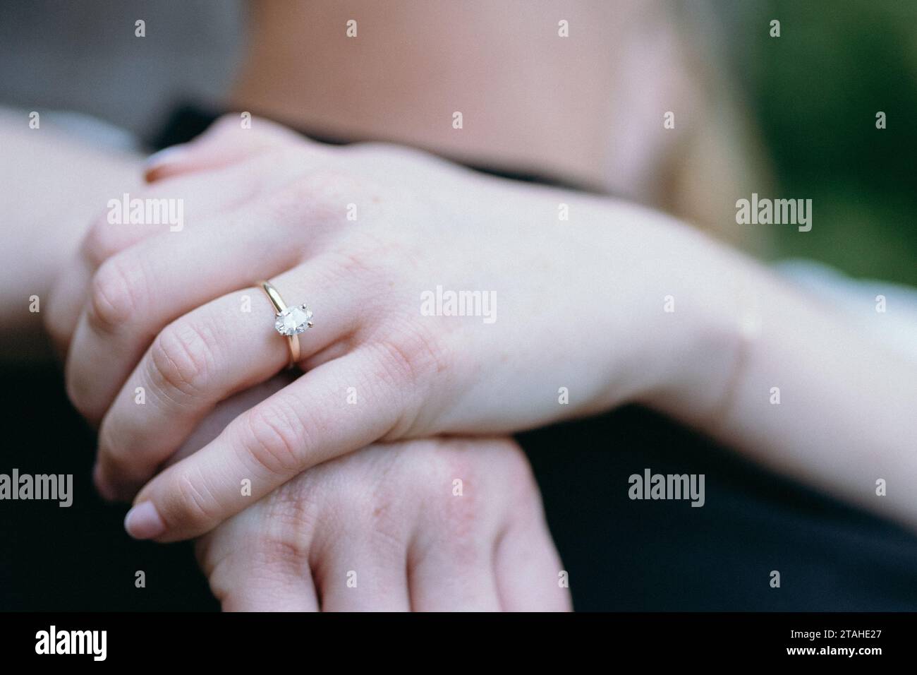 Wrapping hands together showing engagement ring Stock Photo Alamy