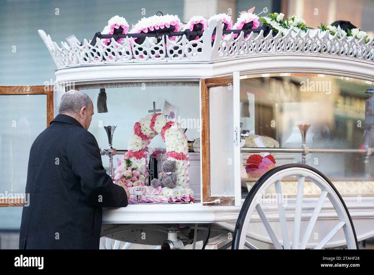 The horse drawn hearse carrying the casket of baby Indi Gregory