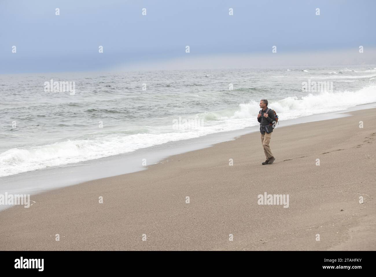 Man walks on beach at Point Reyes National Seashore Stock Photo