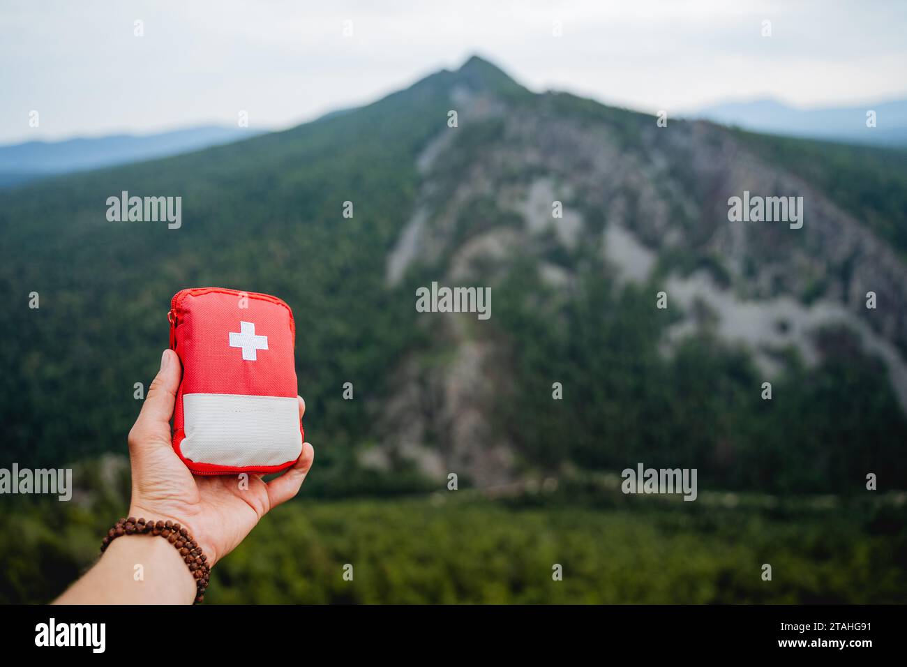 demonstration of a first aid kit on a hike, hand holding a first aid Stock Photo