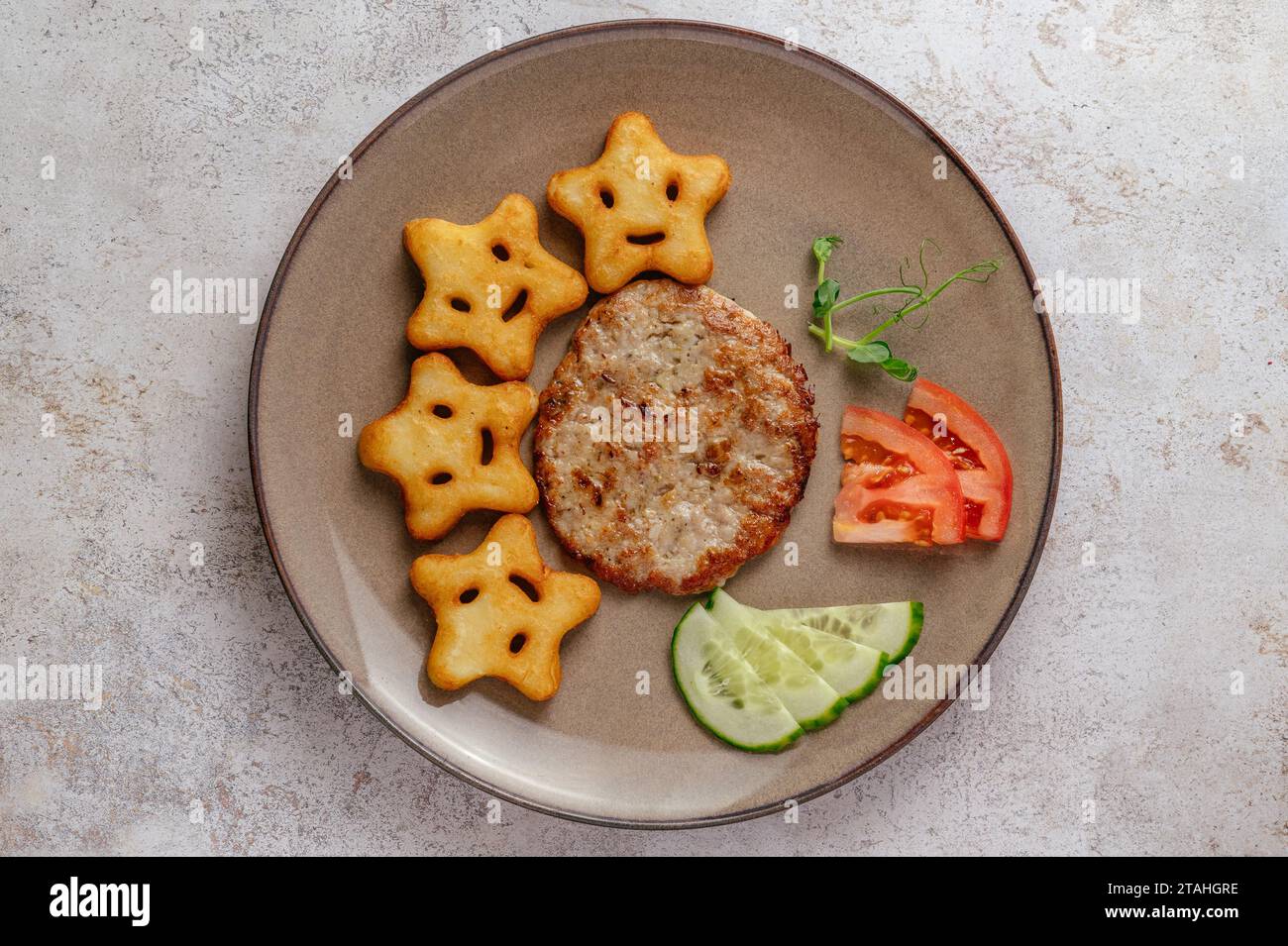 beef patty and potatoes on a plate. food for children Stock Photo