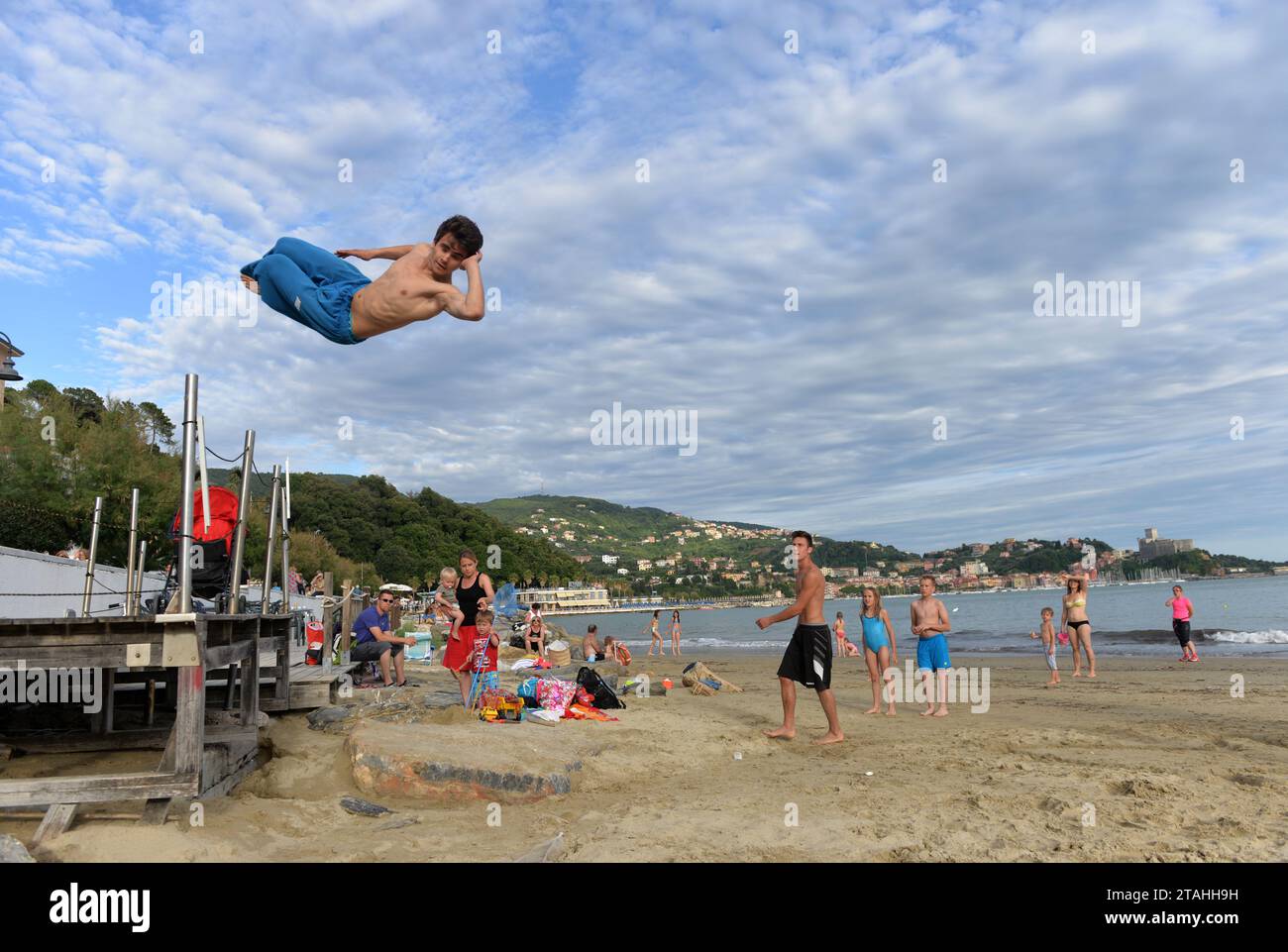 LERICI, ITALY - JUNE 15, 2016: Guy jumping on the beach in Lerici, Italy. Stock Photo