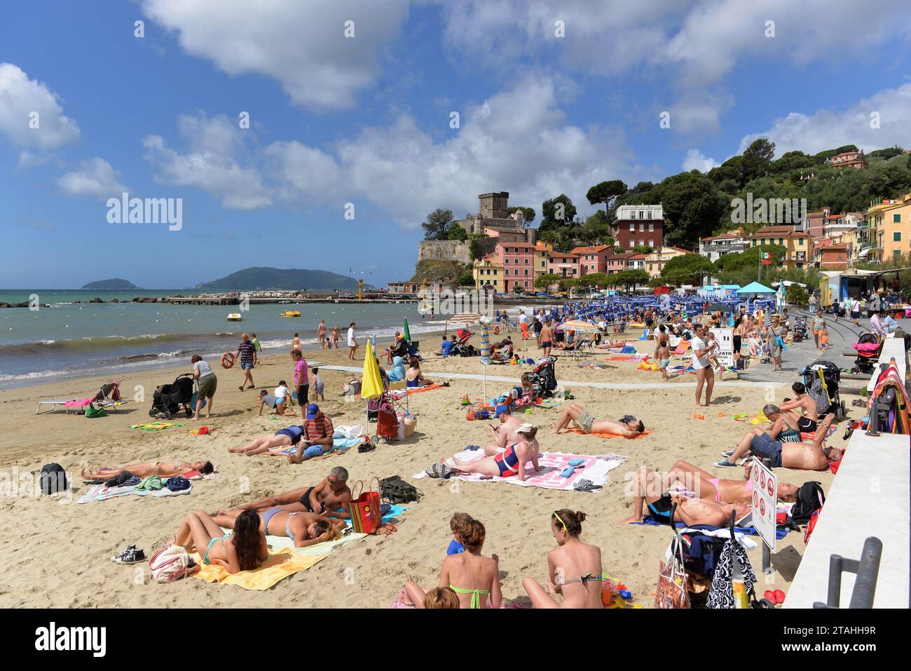 SAN TERENZO, LERICI, ITALY - JUNE 16, 2016: San Terenzo (St. Terenzo) beach crowded with bathers people in a June day. Stock Photo