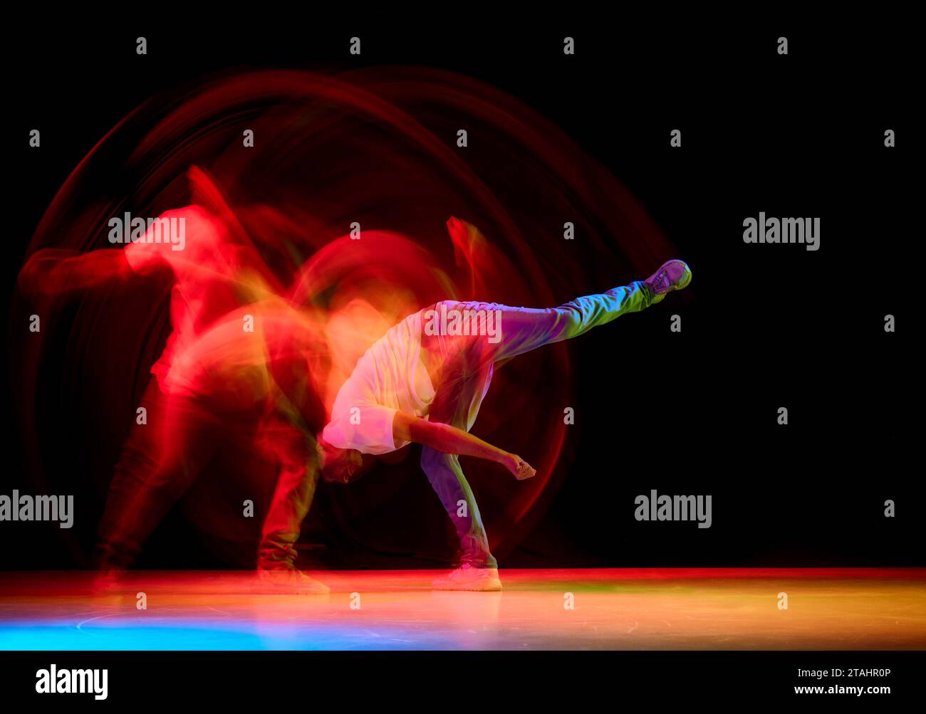 Young sportive guy dancing hip-hop, breakdance against black studio ...