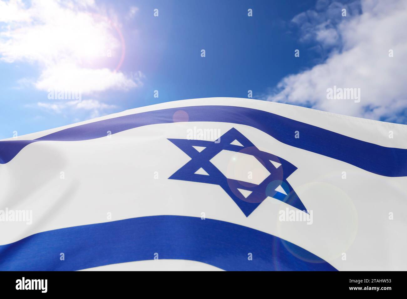 National flag of Israel against blue sky with clouds Stock Photo - Alamy