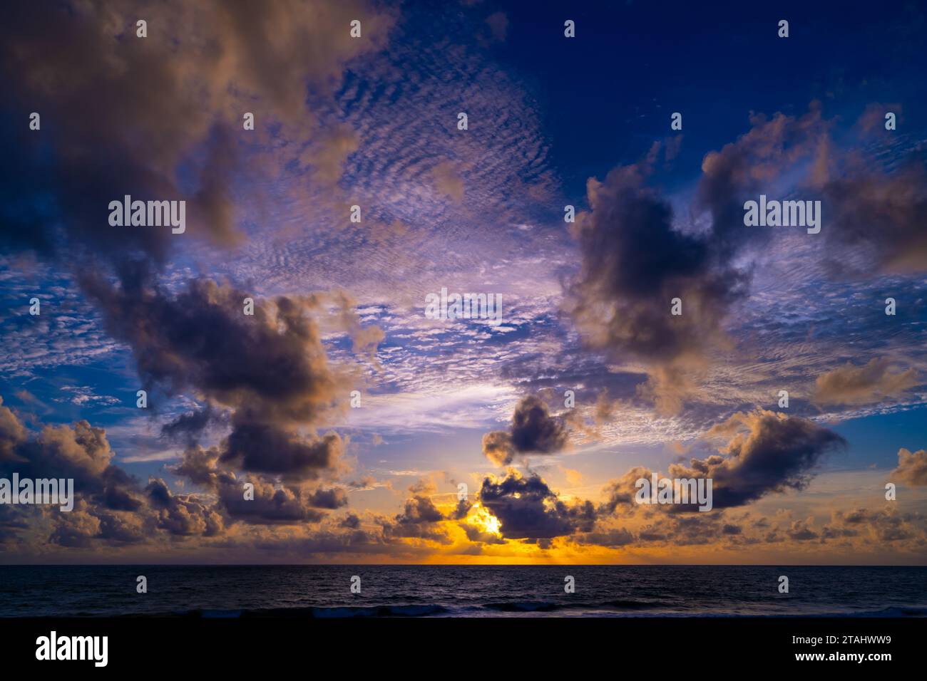 Beautiful colorful sunset or sunrise sky over sea with dramatic clouds ...