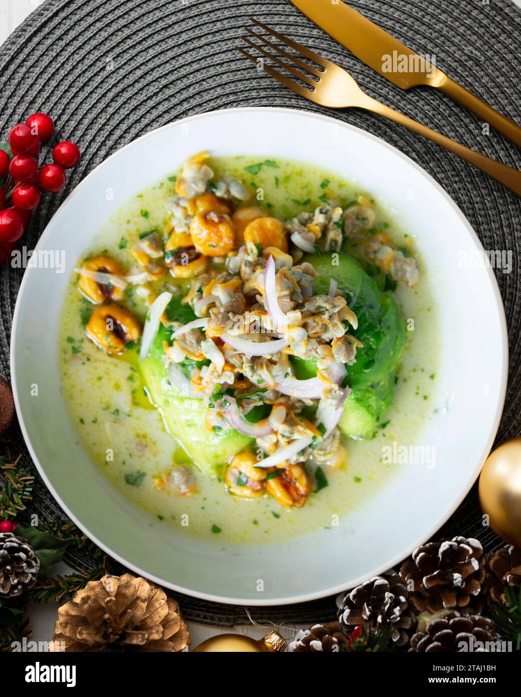 Ceviche with cockles and avocado. Christmas food served on a table decorated with Christmas motifs. Stock Photo