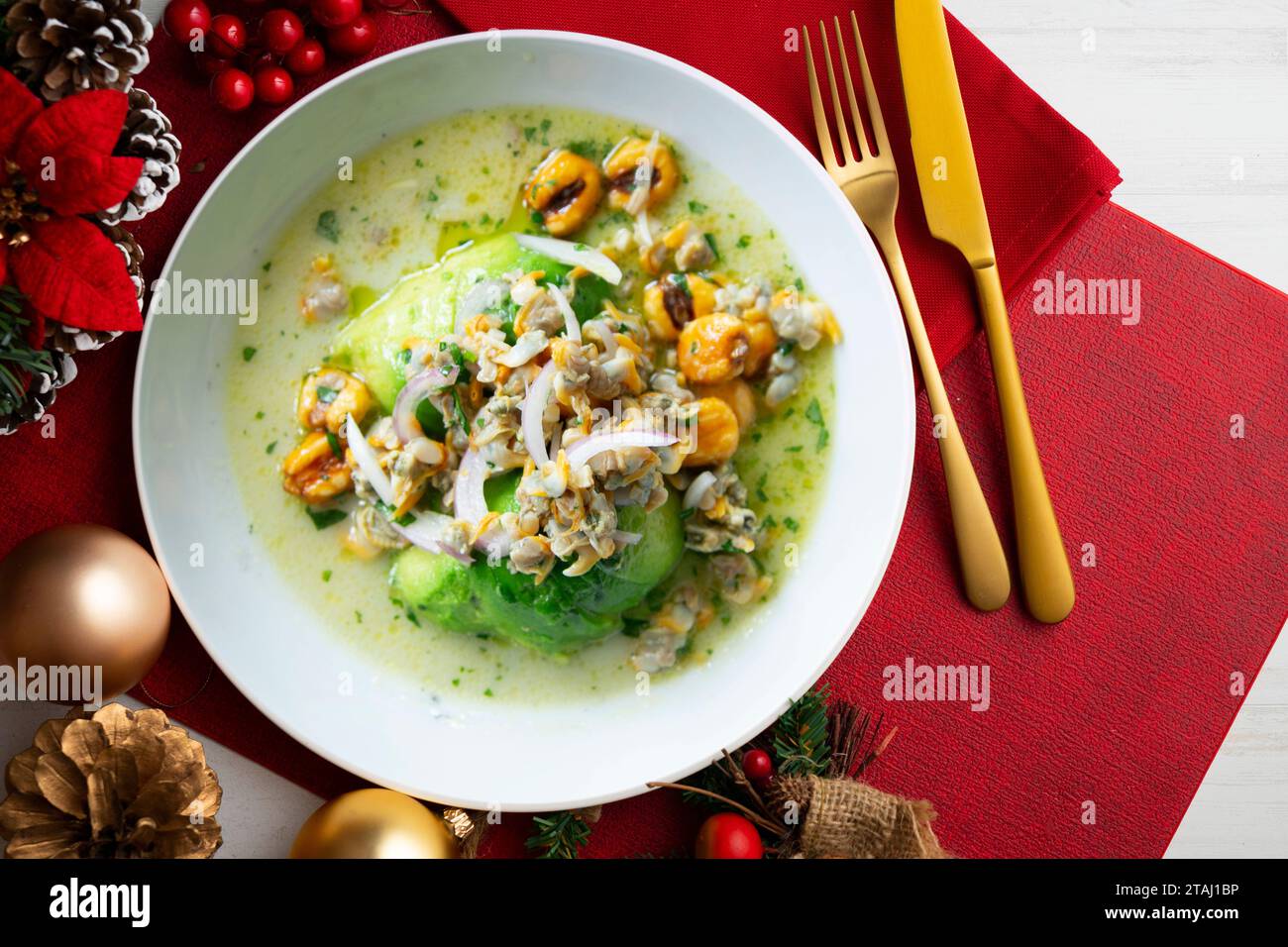 Ceviche with cockles and avocado. Christmas food served on a table decorated with Christmas motifs. Stock Photo