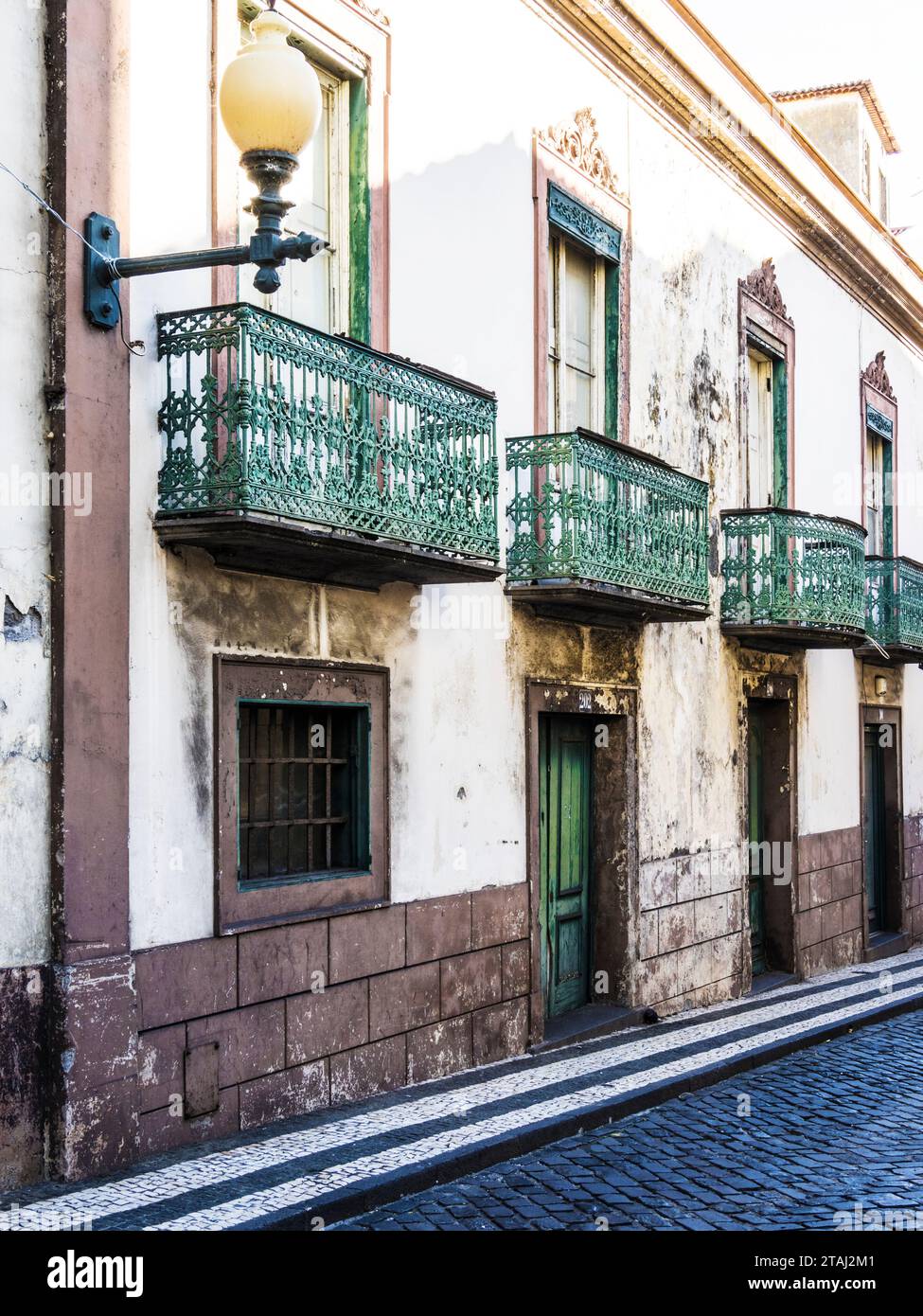 An narrow cobbled street in Funchal, Madeira, Portugal. Stock Photo