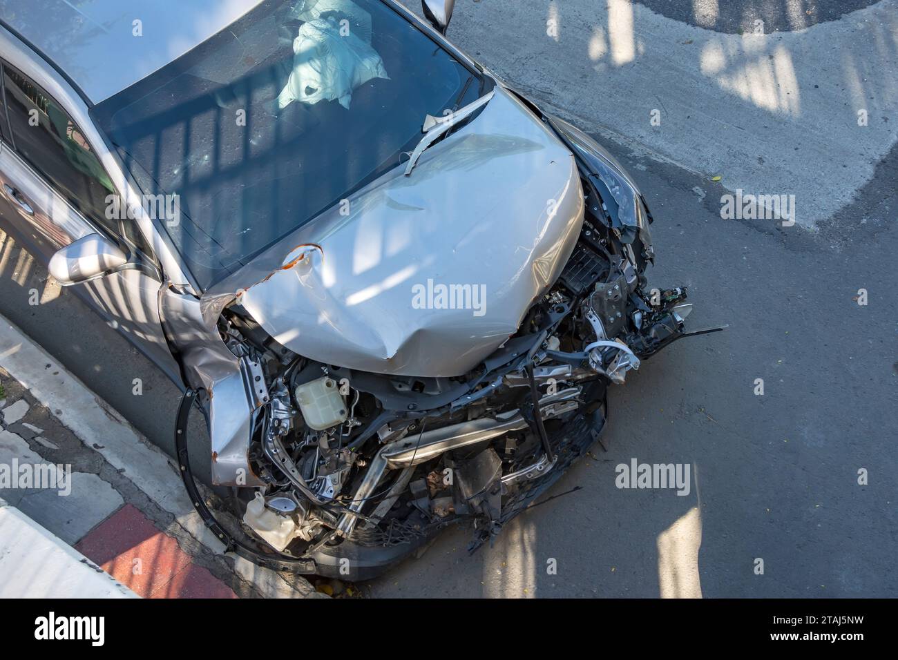 Car crashed into a damaged hood after a strong impact accident on the