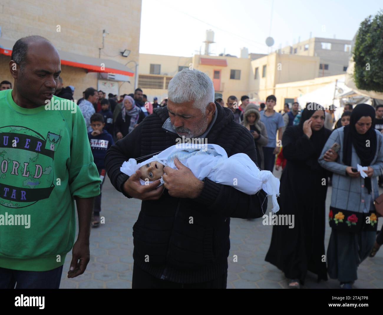 Dead body of a 5-month-old Palestinian baby named Muhammad Hani Al-Zahar, is brought to the Al-Aqsa Martyrs Hospital Dead body of a 5-month-old Palestinian baby named Muhammad Hani Al-Zahar, is brought to the Al-Aqsa Martyrs Hospital by his mother Asmahan Attia Al-Zahar and grandfather Attia Abu Amra after the Israeli airstrikes at the end of the humanitarian pause in Deir Al-Balah, Gaza on December 1, 2023. 32 Palestinians were killed within 3 hours of the end of the humanitarian pause in Gaza. Photo by Omar Ashtawy apaimages Dair El-Balah Gaza Strip Palestinian Territory 011223 Dair Balah OS Stock Photo