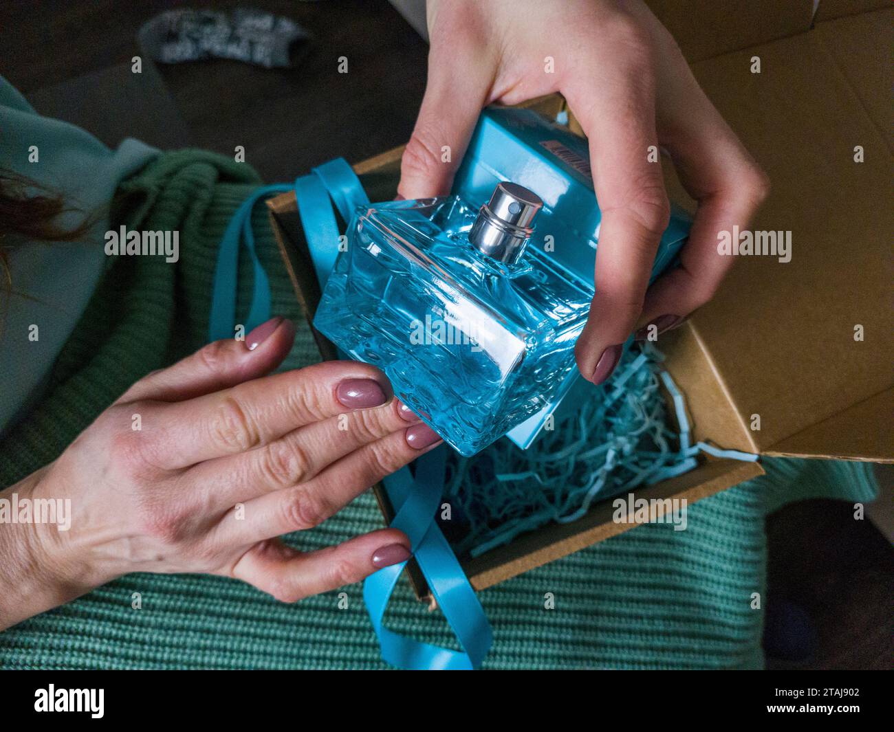 Close up shot of the woman holding unwrapped gift box Stock Photo