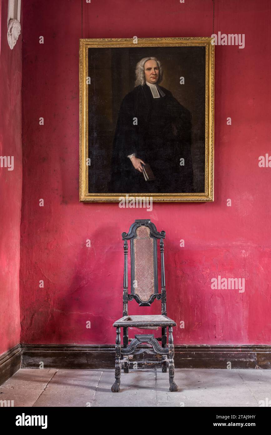Gilt framed reverend in wig above chair at Wolfeton House, Dorset, England, UK. Stock Photo