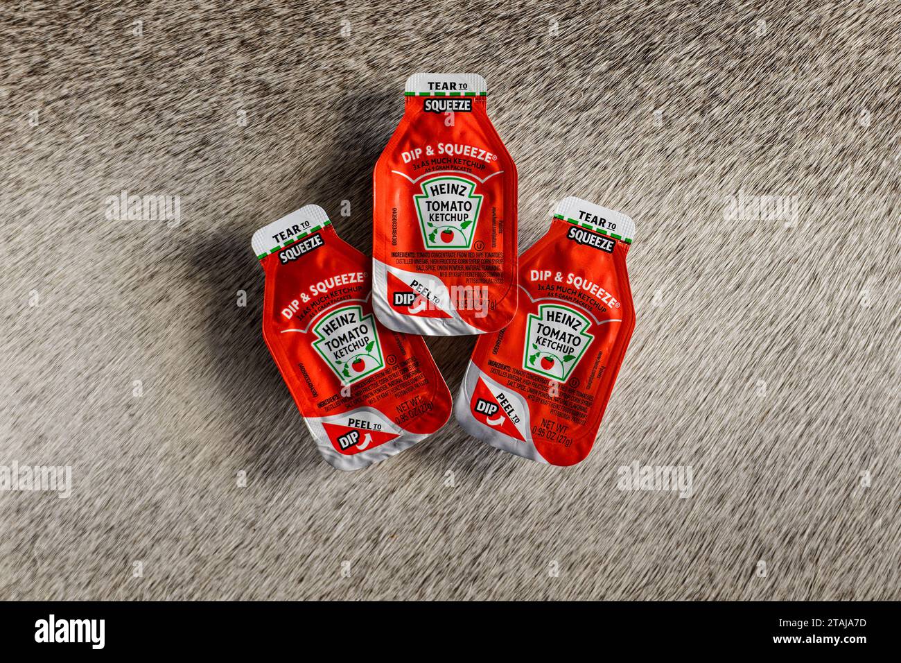 Chandler, AZ - Nov. 24, 2023: Dip and Squeeze style single serve packets of Heinz Tomato Ketchup Stock Photo