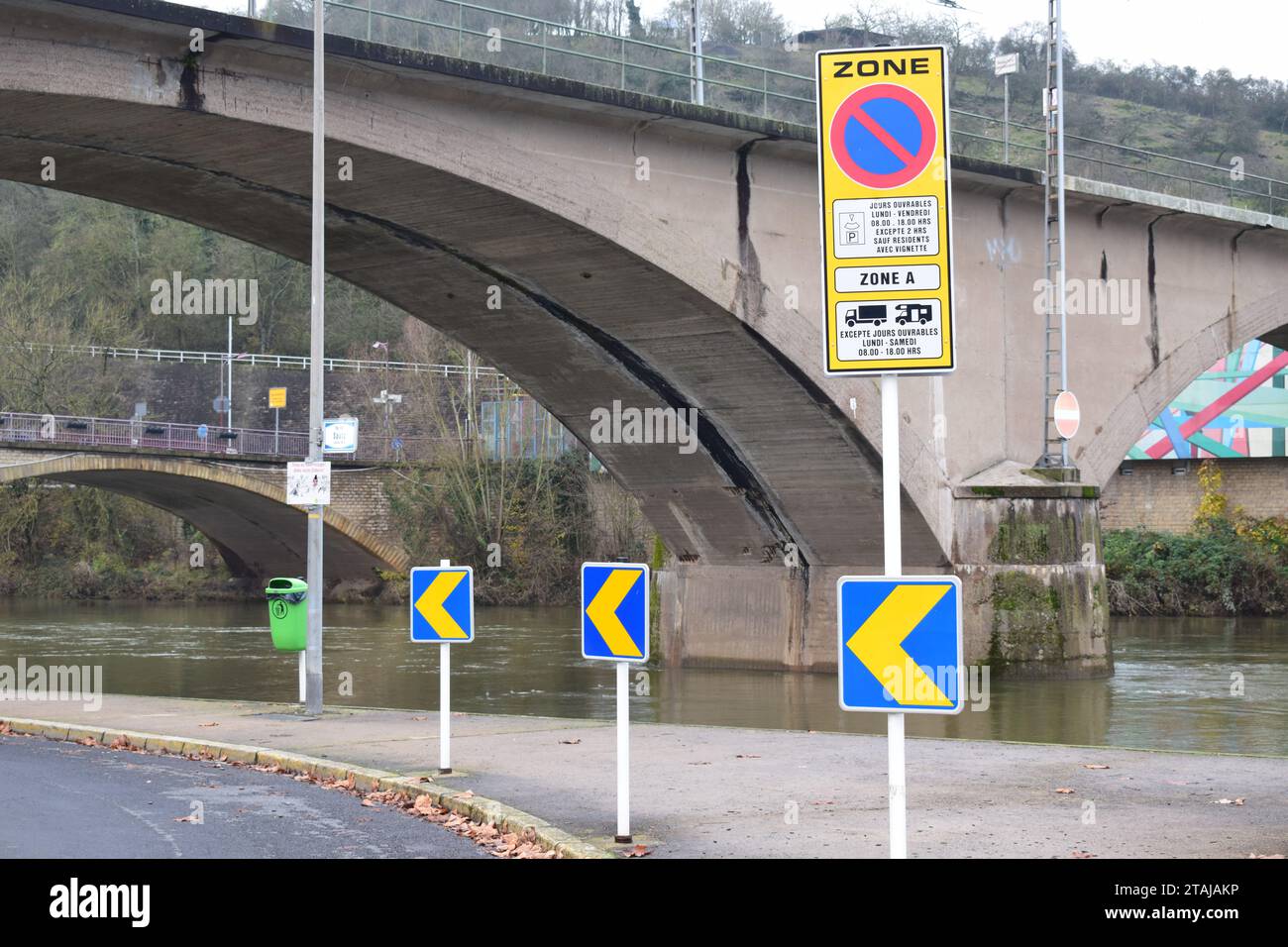 blue and yellow curve warning signs at the water Stock Photo - Alamy