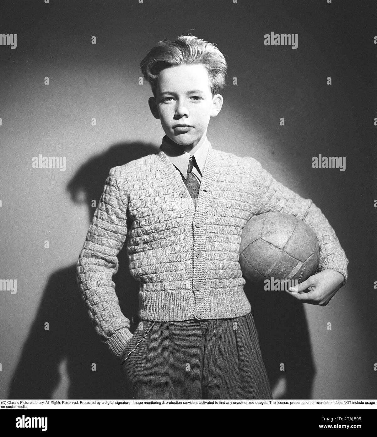 boy-of-the-1940s-a-boy-is-standing-in-a-the-photographers-studio