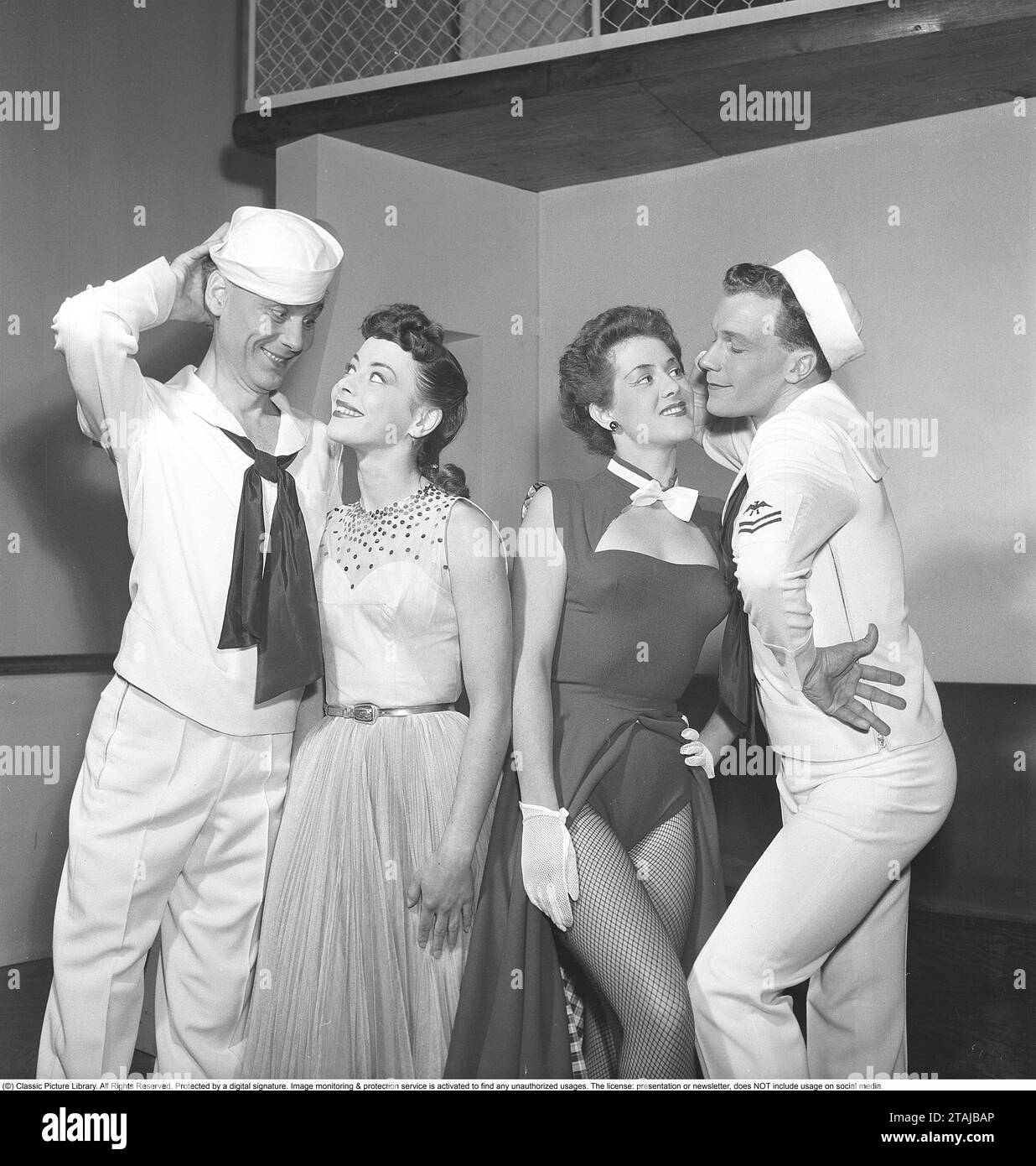 Revue in the 1950s. Two men dressed in sailor's clothes stand with two women. The scene is from a rehearsal at a Stockholm theater in 1952. Kristoffersson ref BH29-1 Stock Photo