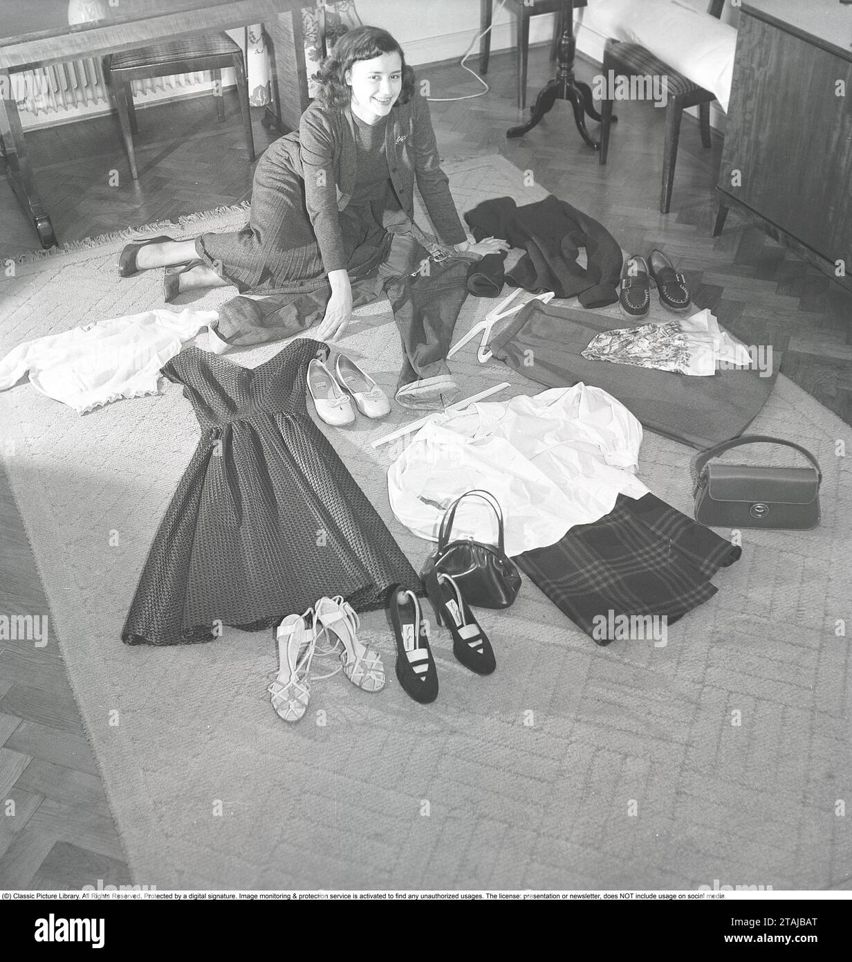 https://c8.alamy.com/comp/2TAJBAT/1950s-girl-actress-harriet-andersson-on-the-floor-where-also-part-of-her-wardrobe-is-seen-a-dress-skirts-in-different-lengths-shoes-and-jackets-in-the-typical-1950s-fashion-style-sweden-1952-kristoffersson-ref-bh81-4-2TAJBAT.jpg