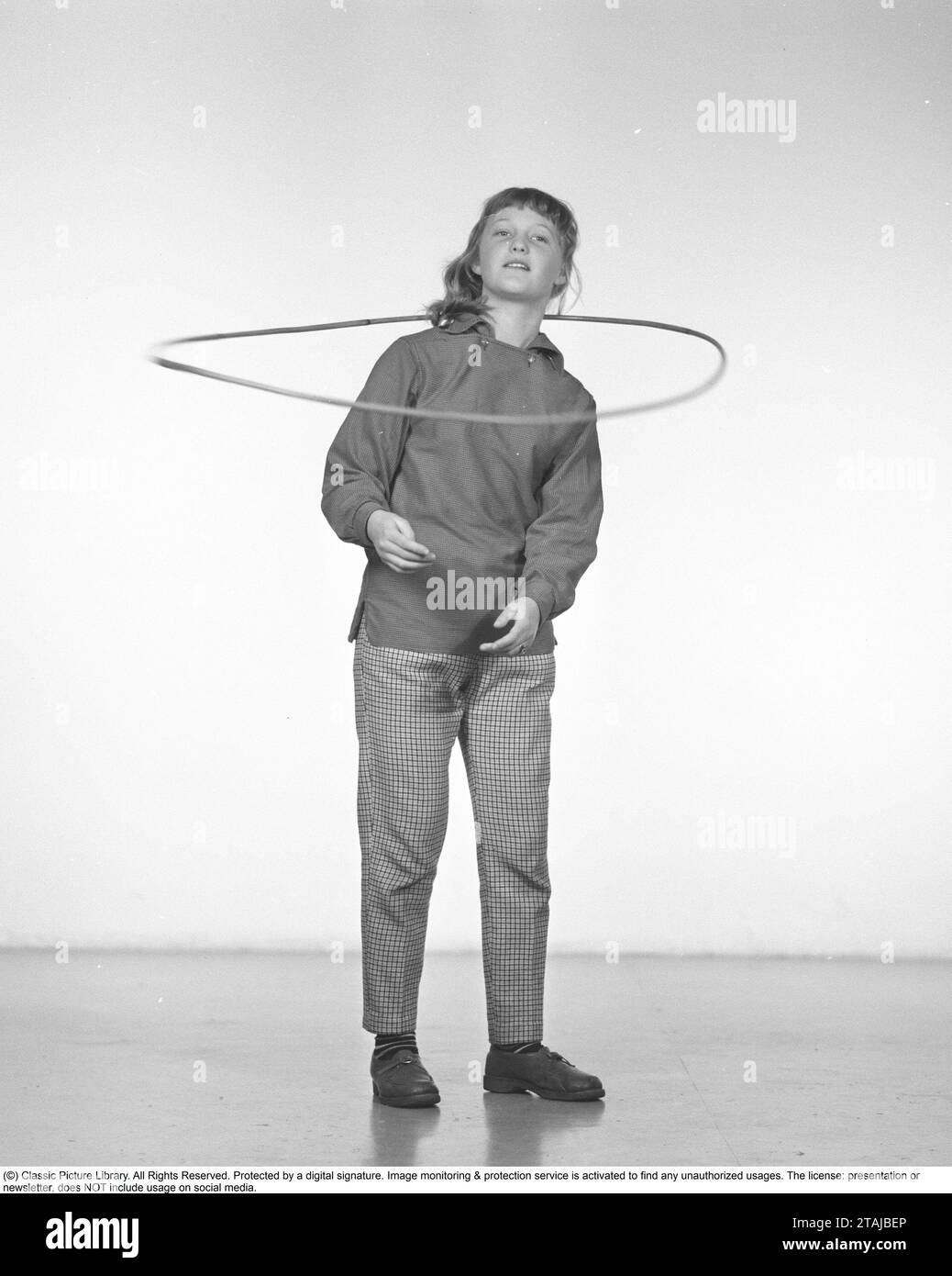 In the 1950s. A girl Hula hooping. A craze that culminated during 1958 with some 20 million hula hoop rings sold in less than four months in the USA. Sweden 1957 Stock Photo