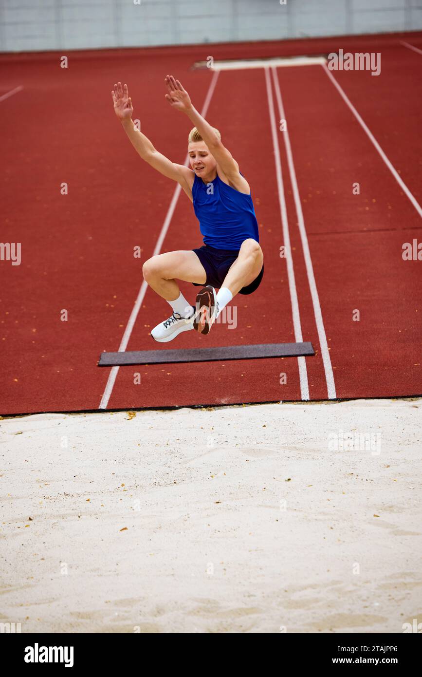 Determination evident in running long jump. Athletic man, sportsman
