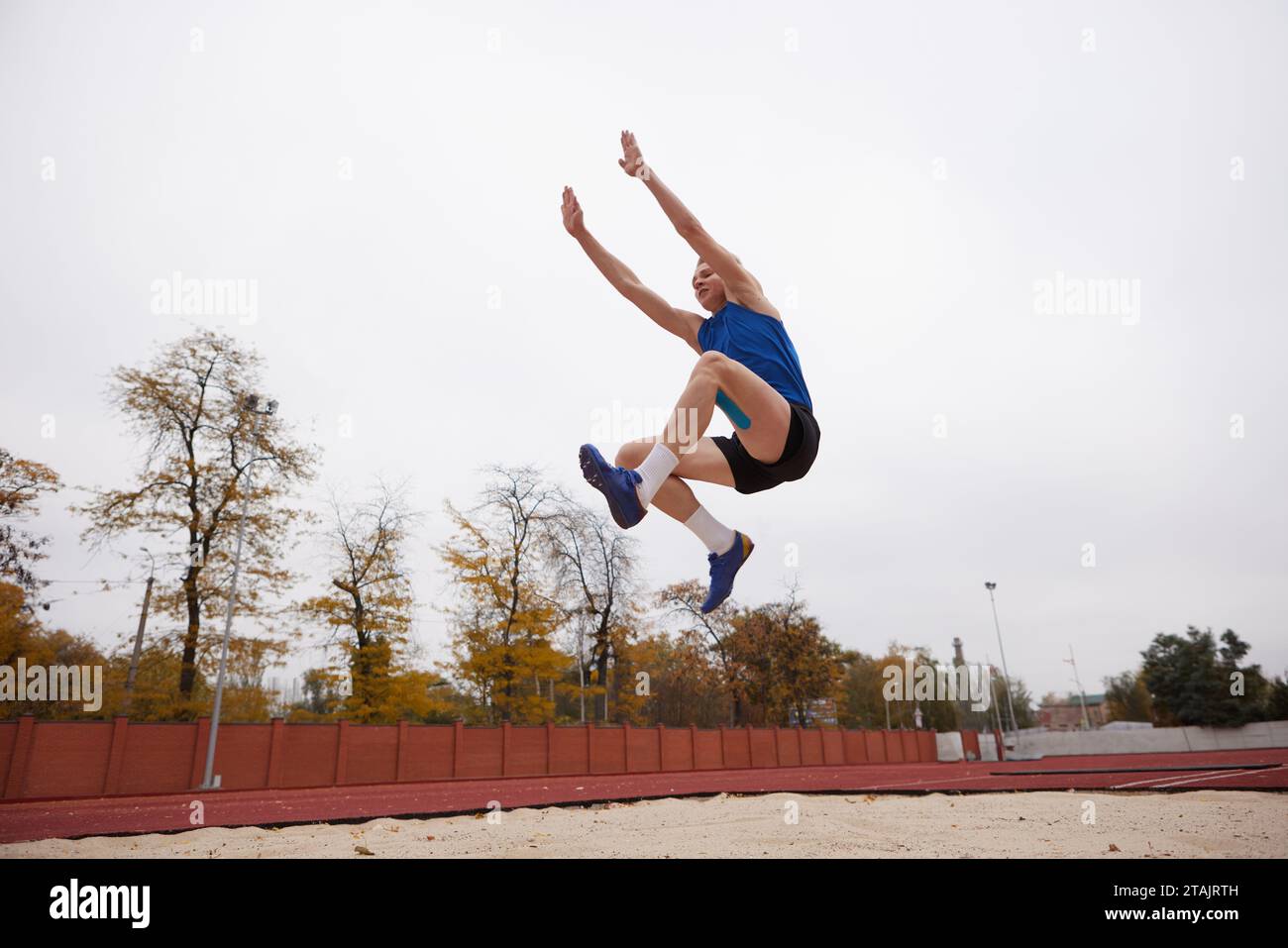 Strategic leap for maximum distance achieved. Dynamic photo of