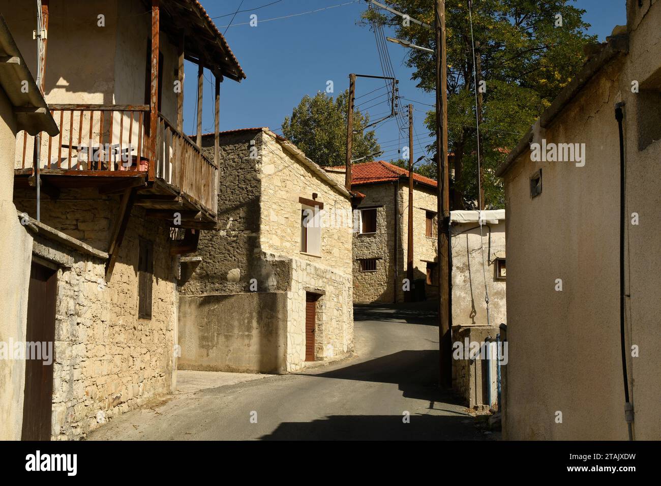 Cyprus, narrow street in the mountain village of Omodos in the Troodos mountains, houses in traditional construction with wooden balcony, Stock Photo